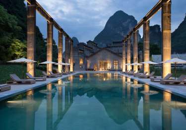 Outside hotel pool with view of mountain in the background.