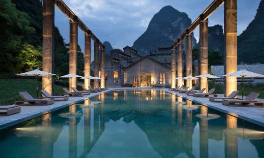 Outside hotel pool with view of mountain in the background.