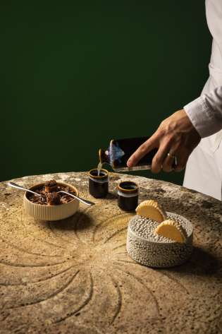 Chef preparing dessert inside hotel .