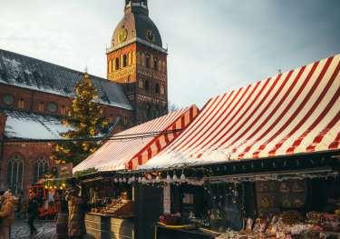 Photo of christmas market with striped awnings .