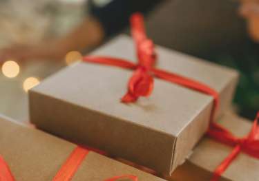 Pile of christmas presents wrapped with red ribbon.