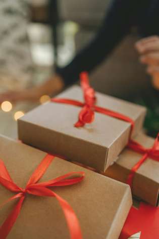 Pile of christmas presents wrapped with red ribbon.