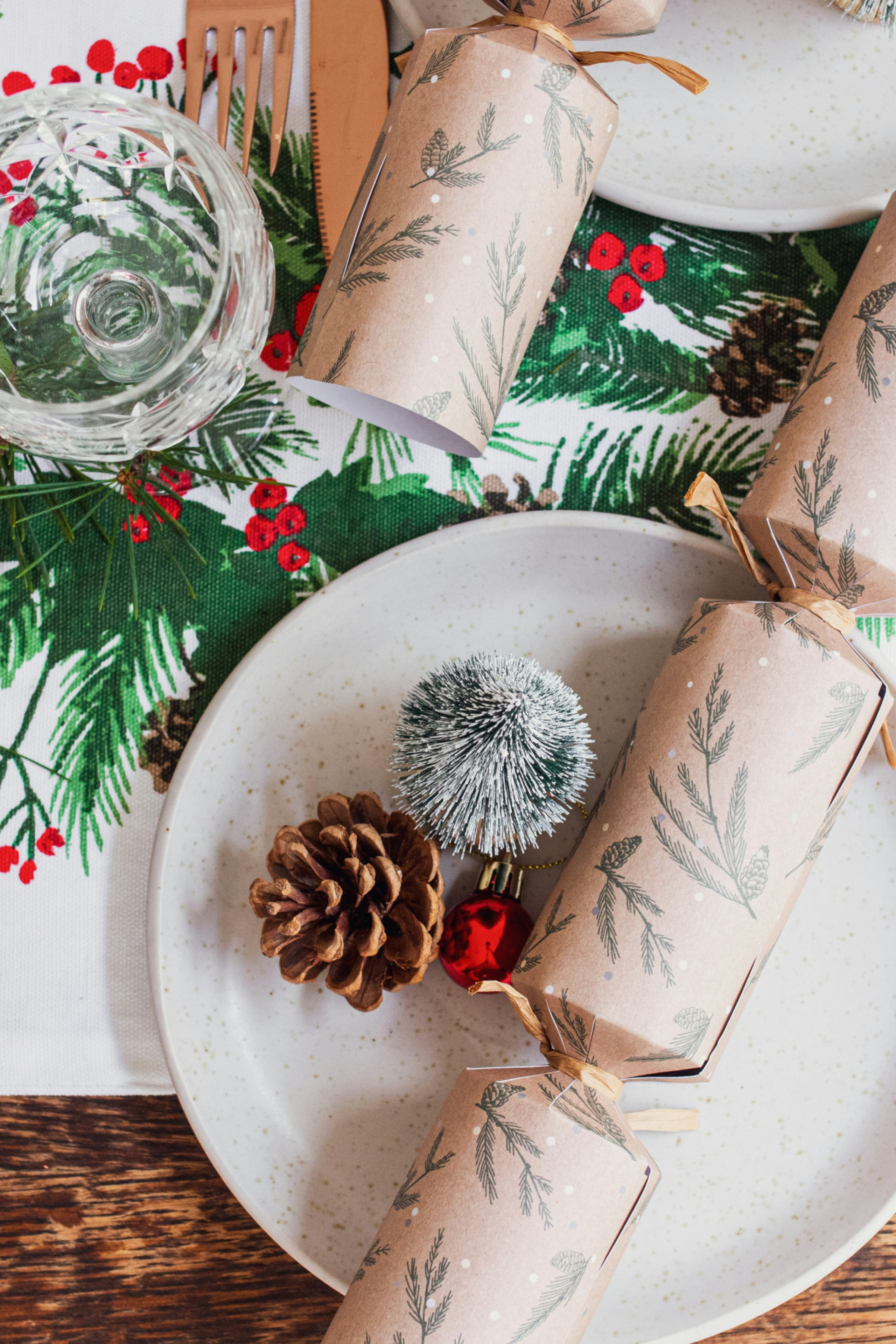 christmas table setting with pinecones and crackers