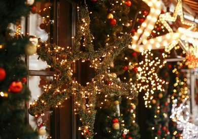 Star wreath with lights at christmas market .