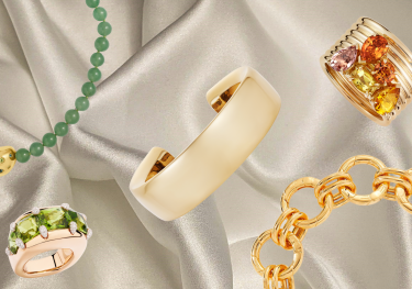 Chunky jewellery pieces on cream silk fabric.