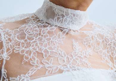 Model wearing wedding dress with lace details.