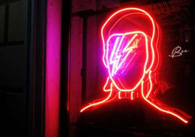 David bowie neon light on wall .