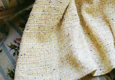 Hem of yellow tweed dress.