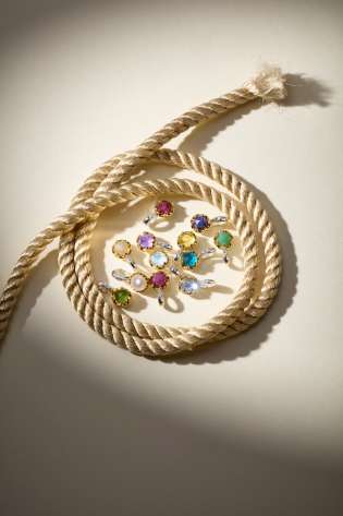 Multi-coloured earrings in a cluster surrounded by rope .