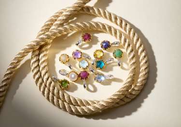 Multi-coloured earrings in a cluster surrounded by rope .