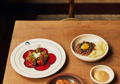 Three dishes placed on table in restaurant.