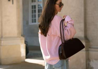 Maria kragmann posing with bag .