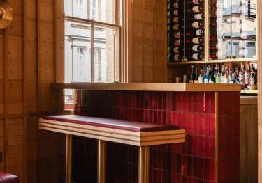 NAKIMUSHI bar area with red-leather stool .