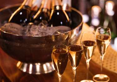 Bottles of fizz with four glasses.