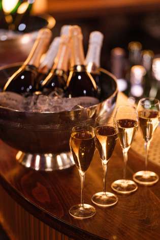 Bottles of fizz with four glasses.