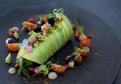 Delicate avocado dish with tomatoes.