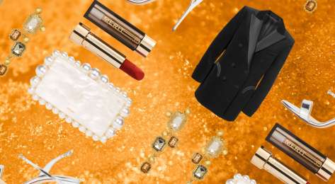 Glam beauty and fashion items on gold glitter background.
