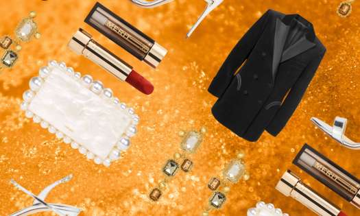 Glam beauty and fashion items on gold glitter background.