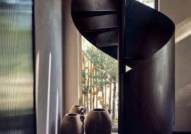 Curved wooden staircase in Greek resort.