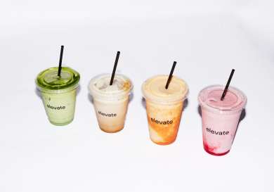 Four smoothies on white background.