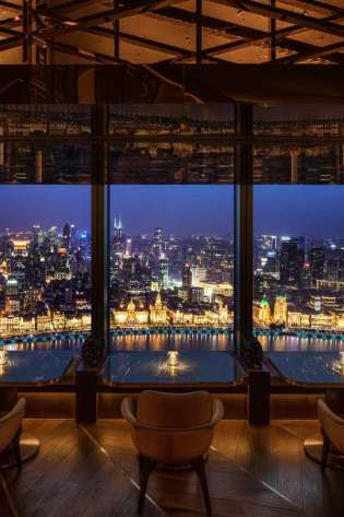 Hotel bar area with skyline views of shanghai.
