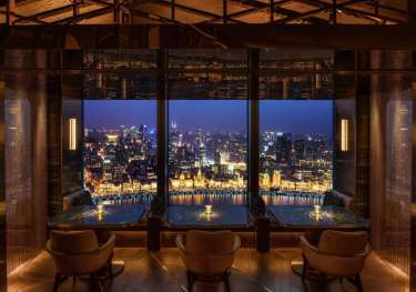 Hotel bar area with skyline views of shanghai.