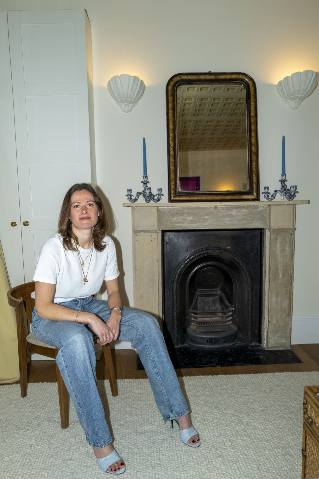 portrait of woman posing in living room on wooden chair