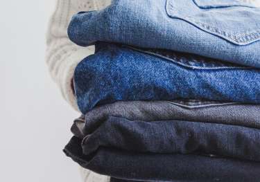Folded pairs of jeans.