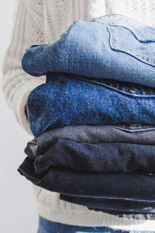 Folded pairs of jeans.
