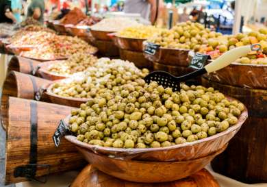 Displays of olives at a french market.