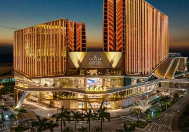 Hotel exterior at night.