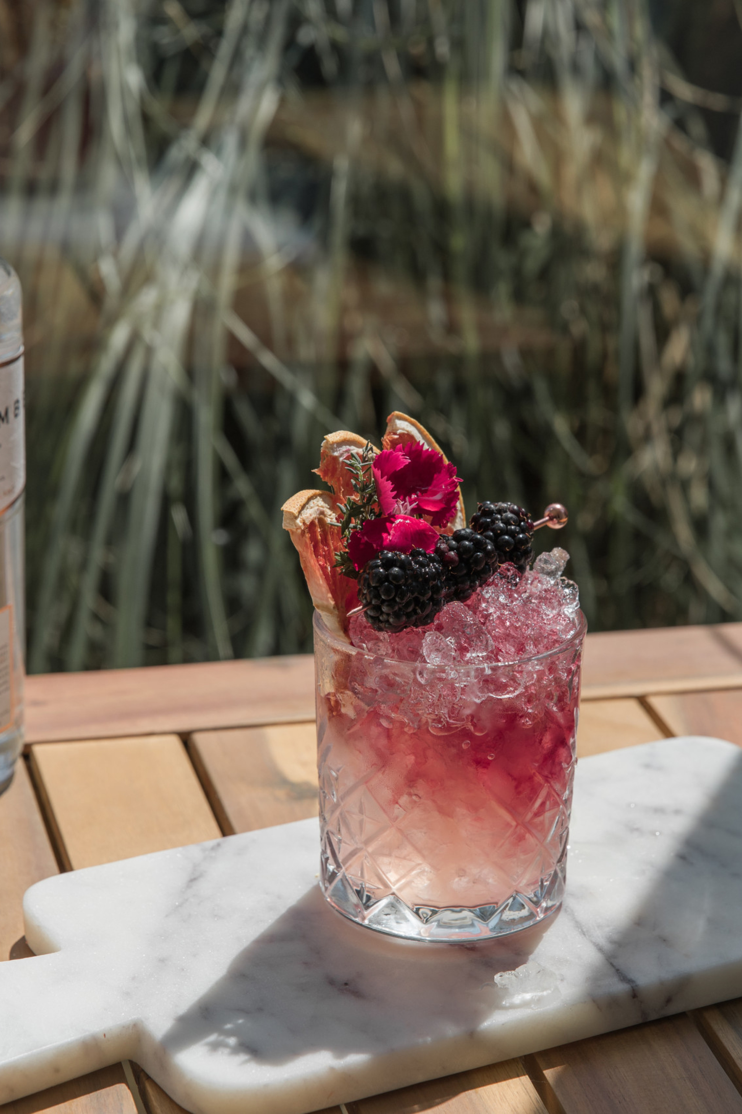 blackberry cocktail on marble serving board