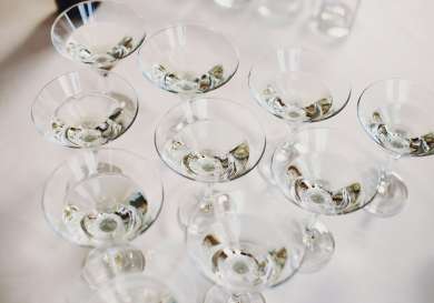 Cocktail glasses arranged on table.