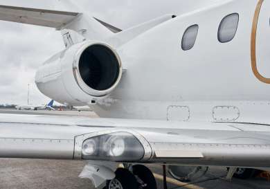 White private jet on tarmac runway.
