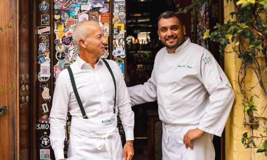 Two people chatting outside shoreditch restaurant .