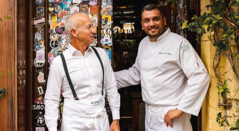Two people chatting outside shoreditch restaurant .