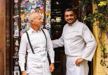 Two people chatting outside shoreditch restaurant .