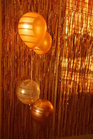 Gold balloons with gold streamer background.