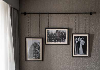A trio of pictures hung up in hotel bedroom.