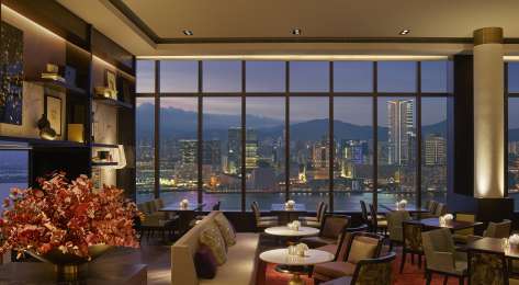 Hotel dining room with view of skyline.