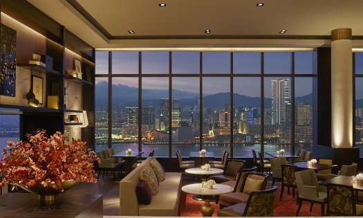 Hotel dining room with view of skyline.