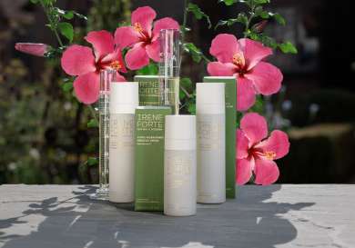 Group shot of skincare products with hibiscus flowers .