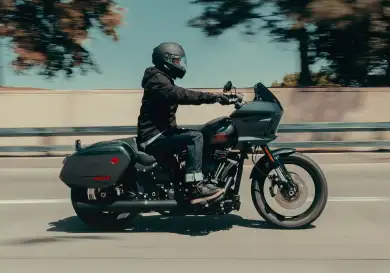 Person riding bike along road .