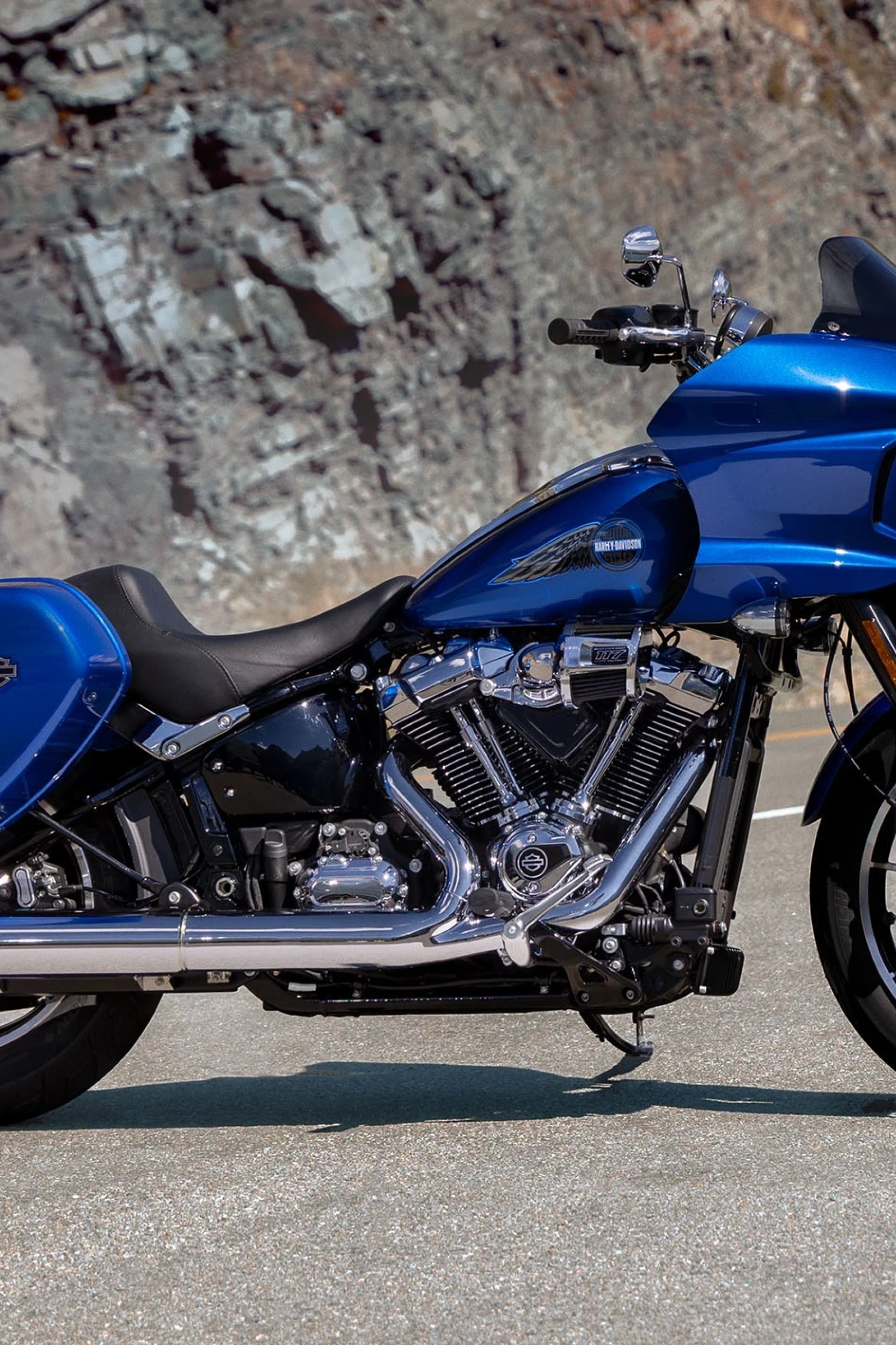 harley davidson blue bike parked on road 