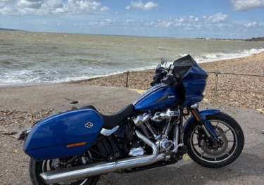 Blue bike parked by sea.