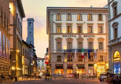 Exterior view of hotel in florence at sunset.