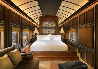 Hotel bedroom with wooden panelling.