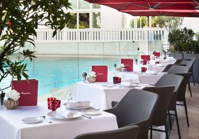 Outdoor restaurant seating at hotel .