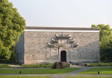 Hotel exterior with temple design around door .