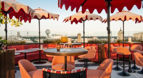 Madrid rooftop with red umbrellas.